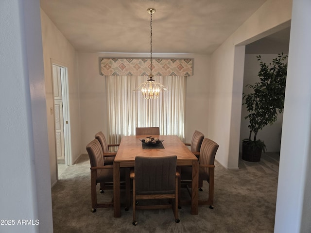 carpeted dining space with a chandelier