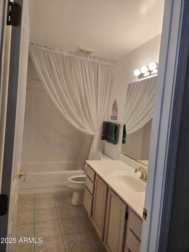 full bath with tile patterned floors, vanity, toilet, and shower / bath combo