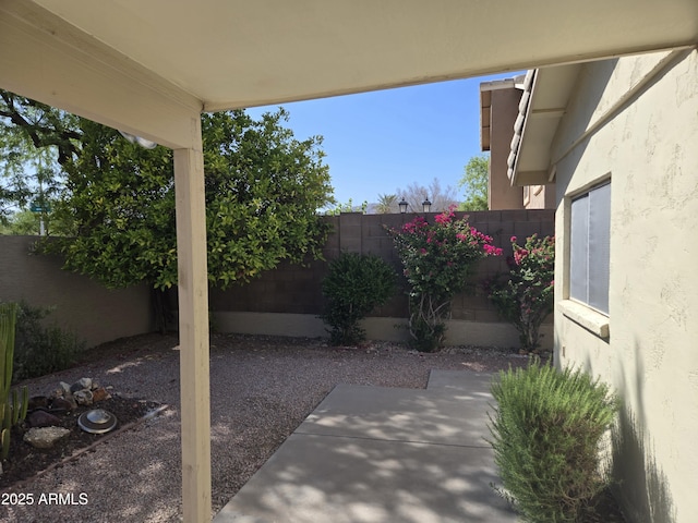 fenced backyard with a patio area