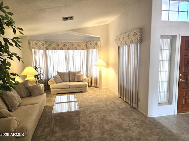 living area featuring carpet and vaulted ceiling