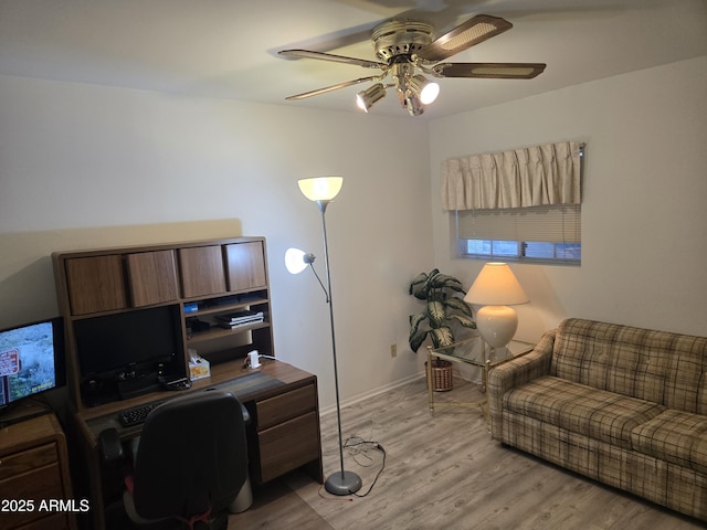 home office featuring ceiling fan, light wood-type flooring, and baseboards