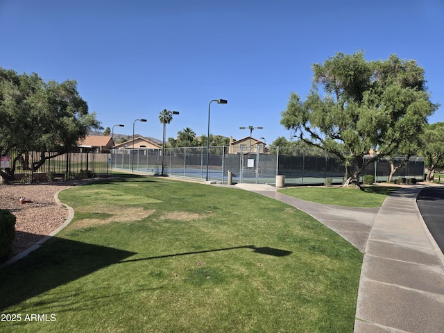 view of property's community with a tennis court