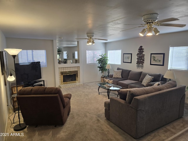 living room featuring ceiling fan, carpet, and a fireplace