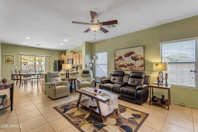 living room with ceiling fan and light tile patterned flooring