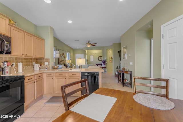 kitchen featuring sink, light tile patterned floors, tasteful backsplash, black appliances, and light brown cabinets