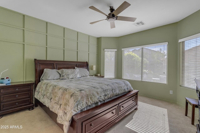 bedroom featuring ceiling fan and light carpet