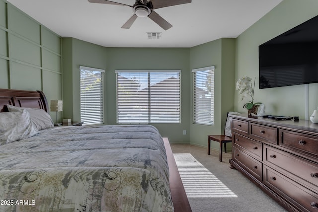 bedroom with light carpet and ceiling fan