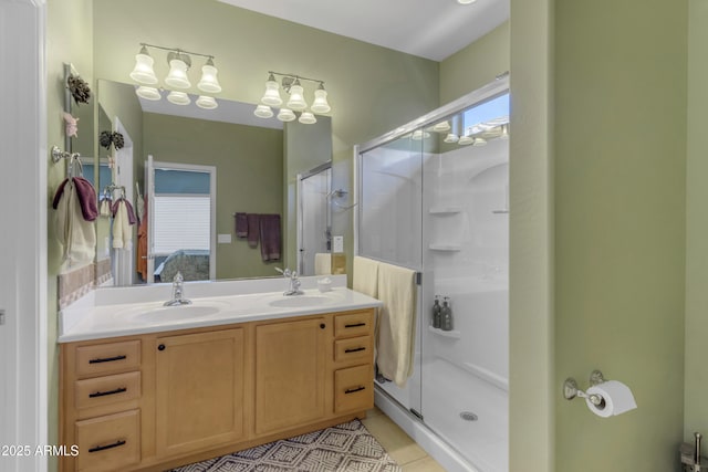 bathroom with walk in shower, a healthy amount of sunlight, tile patterned flooring, and vanity