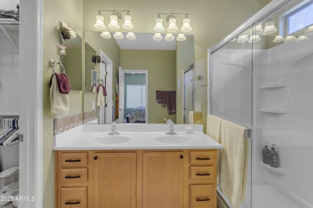 bathroom featuring vanity and a shower with shower door