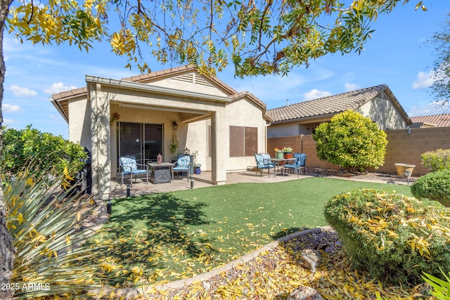 back of property featuring a yard and a patio area