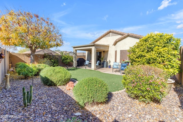 back of property with a patio area and a lawn