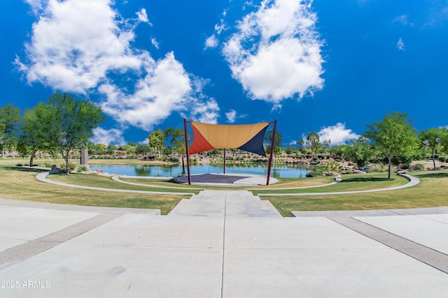 view of property's community featuring a yard and a water view