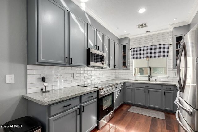 kitchen featuring light stone counters, stainless steel appliances, sink, and gray cabinetry