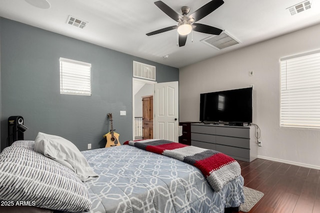 bedroom with dark hardwood / wood-style floors and ceiling fan