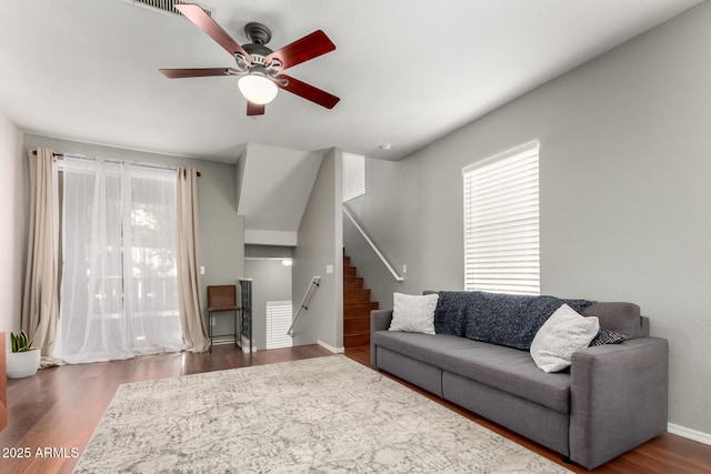 living room with dark wood-type flooring, plenty of natural light, and ceiling fan