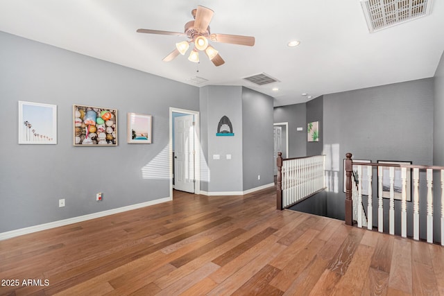 spare room with ceiling fan and wood-type flooring