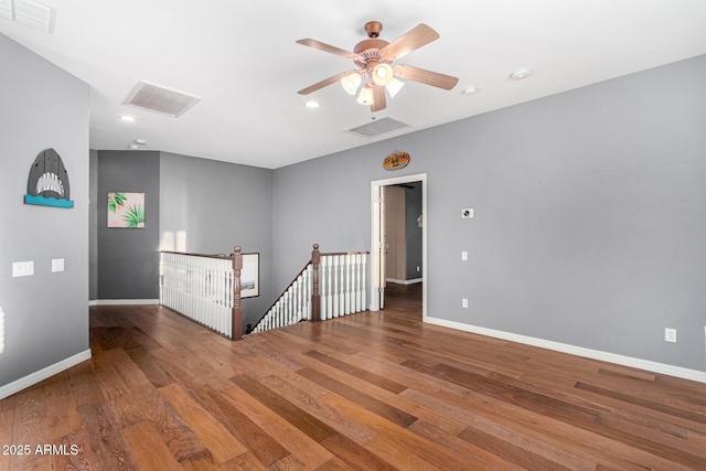 empty room with ceiling fan and hardwood / wood-style floors