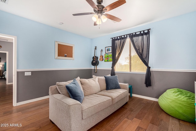 living room featuring hardwood / wood-style flooring and ceiling fan