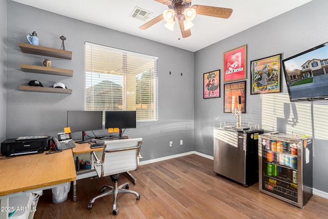 office area with ceiling fan and light hardwood / wood-style flooring