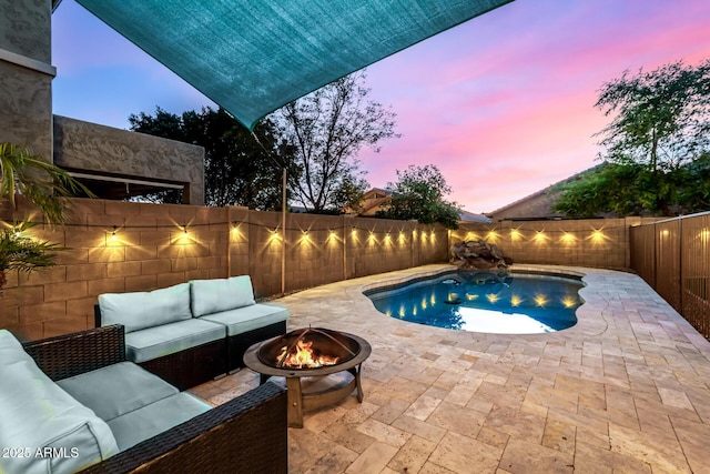 pool at dusk with an outdoor living space with a fire pit and a patio