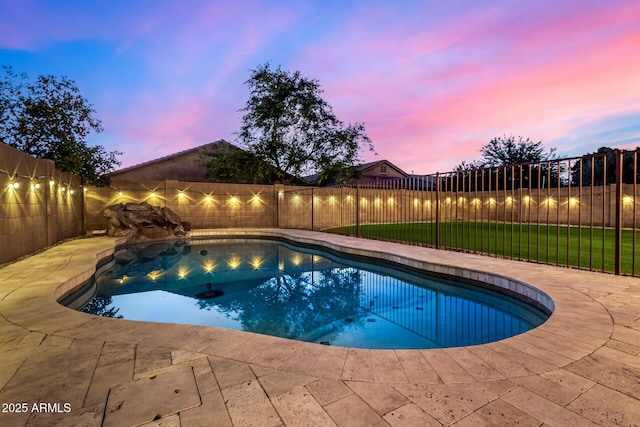 pool at dusk featuring a patio