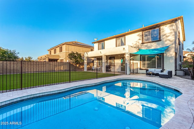 view of pool with an outdoor hangout area, a patio area, and a yard