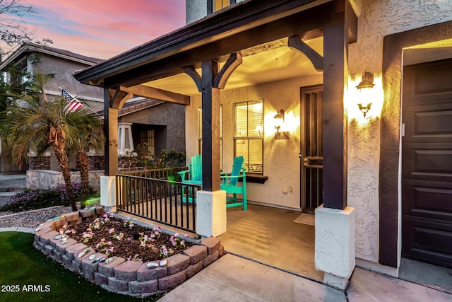 exterior entry at dusk with covered porch