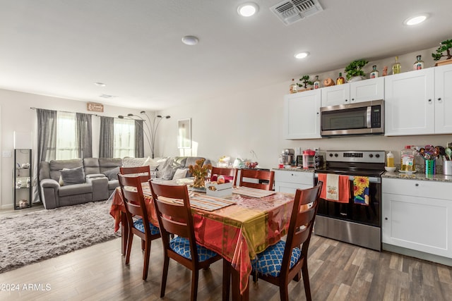 dining area featuring dark wood-type flooring