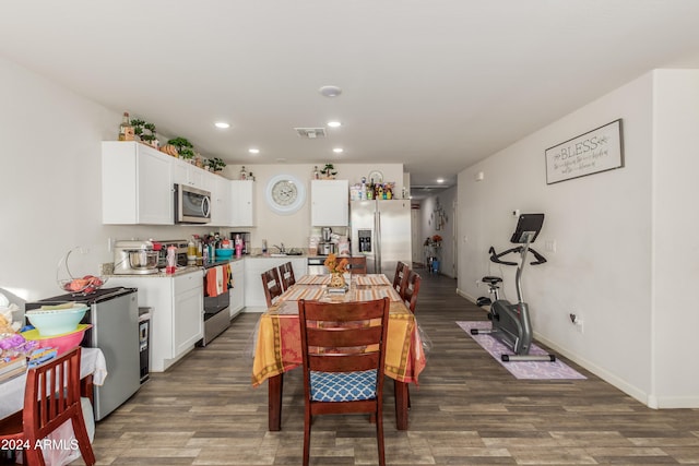 dining room with dark hardwood / wood-style floors and sink