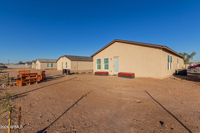 rear view of property with central air condition unit