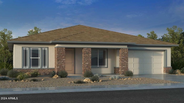 view of front of property with stucco siding, driveway, a shingled roof, a garage, and brick siding