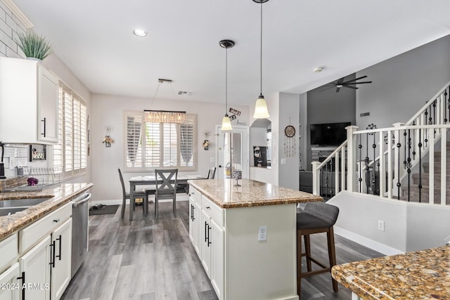 kitchen with wood finished floors, baseboards, white cabinets, a ceiling fan, and dishwasher