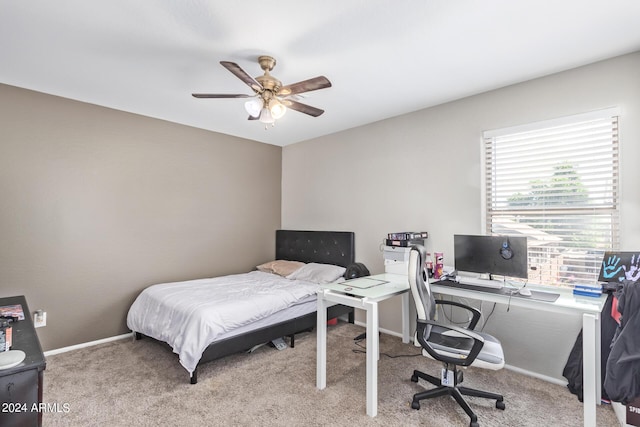 carpeted bedroom with a ceiling fan and baseboards