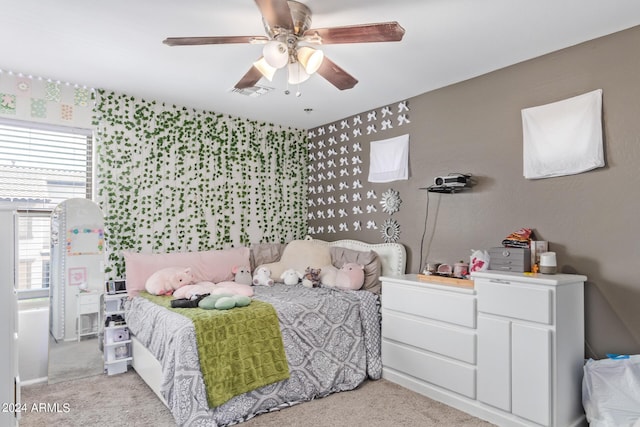 bedroom with visible vents, ceiling fan, light carpet, and wallpapered walls