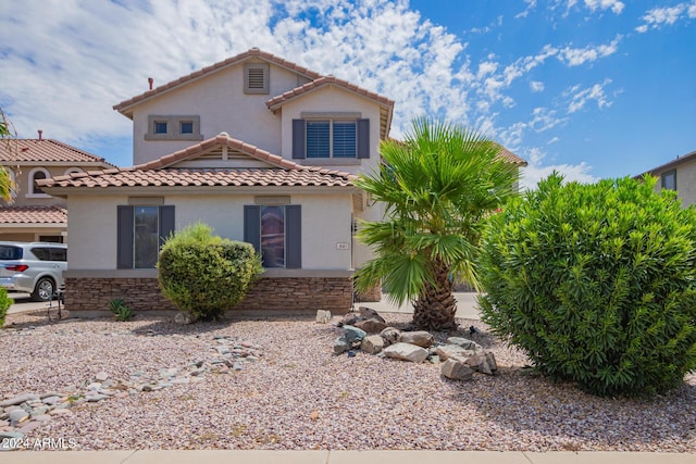 view of front of home featuring stucco siding, a tiled roof, and stone siding