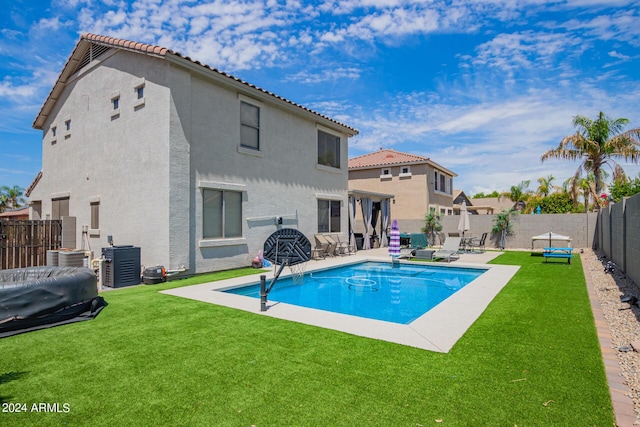 view of pool featuring a lawn, a fenced backyard, a patio area, and a fenced in pool