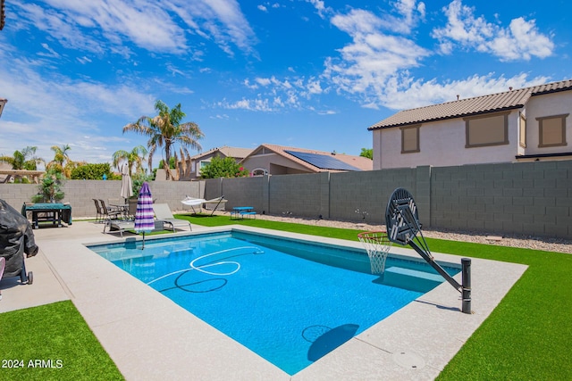 view of swimming pool with a fenced backyard, a fenced in pool, and a patio
