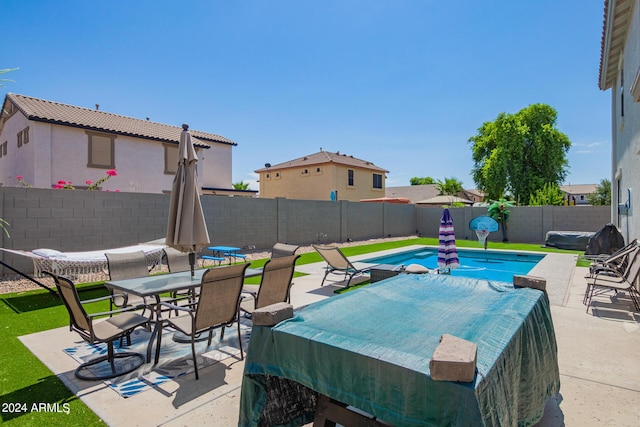 view of swimming pool with a fenced backyard, outdoor dining space, and a patio area