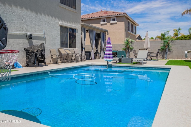 view of swimming pool with a patio, fence, and a fenced in pool