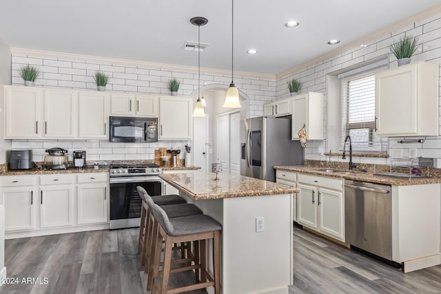 kitchen featuring a sink, white cabinets, and stainless steel appliances