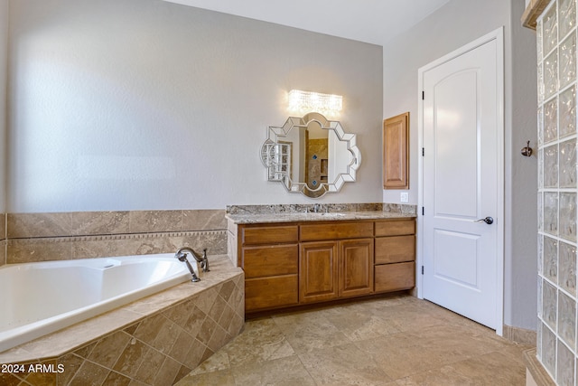 bathroom featuring vanity and a relaxing tiled tub