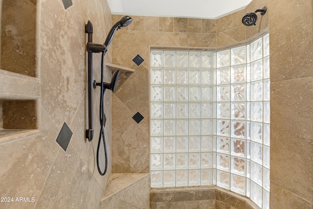 bathroom featuring tile walls and tiled shower