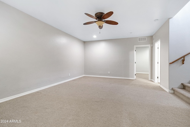 carpeted spare room featuring ceiling fan