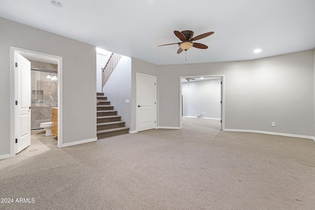 unfurnished living room with light carpet and ceiling fan