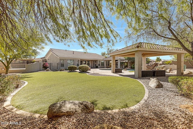 rear view of house with an outdoor hangout area, a yard, a gazebo, and a patio area