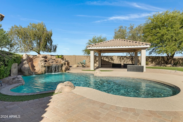 view of pool with a patio, a gazebo, and pool water feature