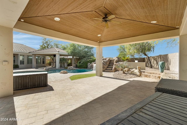 view of patio / terrace with ceiling fan, a fenced in pool, and a gazebo