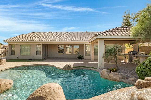 view of pool featuring a grill and a patio area