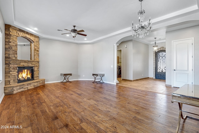 unfurnished living room featuring hardwood / wood-style floors, ceiling fan, and a fireplace