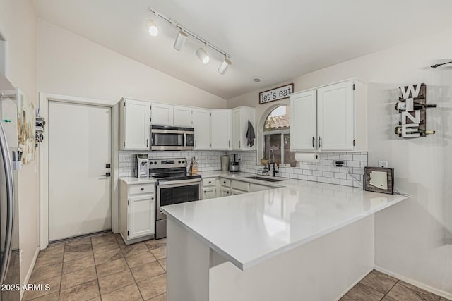 3856 E Encinas Ave, Gilbert, AZ 85234 - kitchen featuring appliances with stainless steel finishes, a sink, a peninsula, decorative backsplash, and light countertops